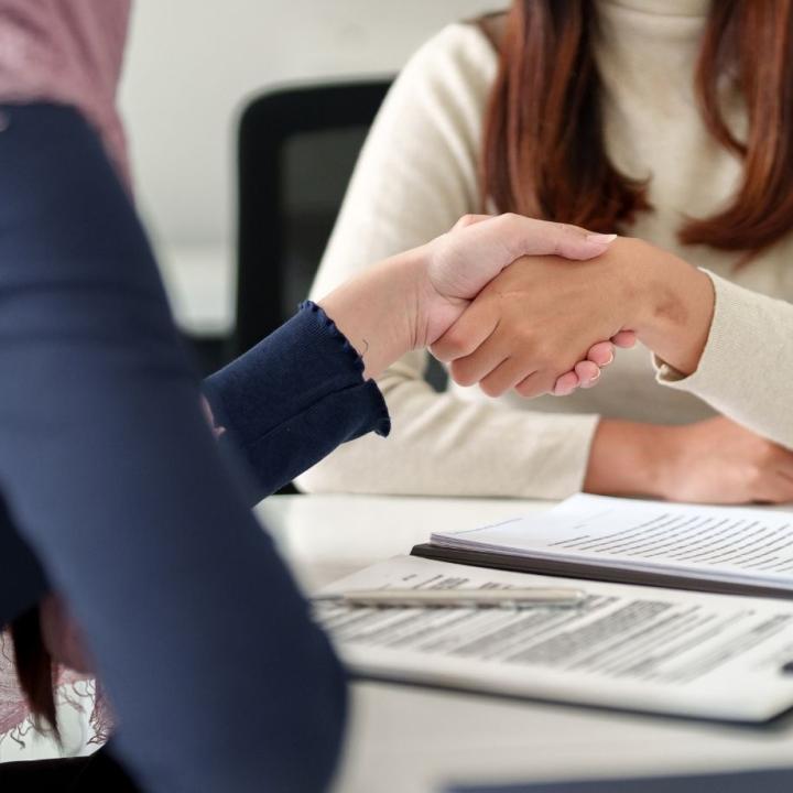 Two people shake hands as a sign of collaboration