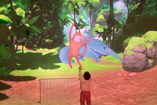 Child interacting in an immersive room.